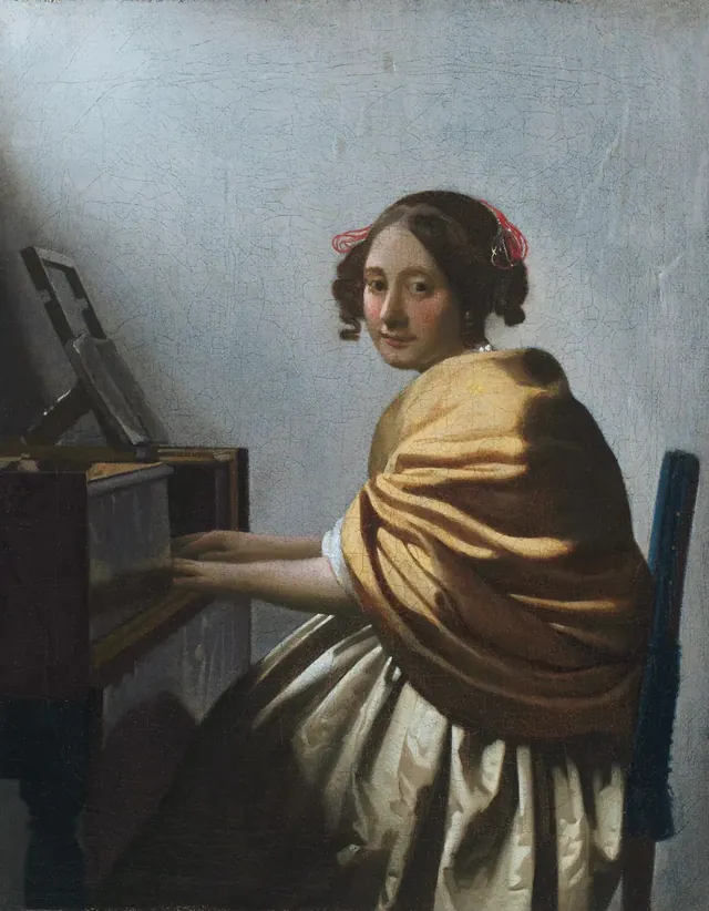 Vermeer’s Young Woman Seated at a Virginal: a young woman in a yellow shawl at a keyboard, looking at the viewer